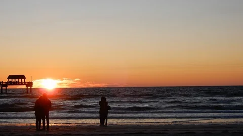 Two Couples Enjoying Romantic Sunset On Beach Ocean With Pier And Seagulls I Stock Footage 127329432