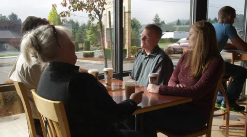 Two couples having coffee at a coffee shop Stock Footage 59163519