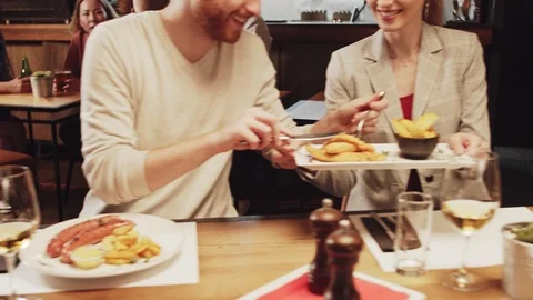 Two couples having diner at restaurant. Couples sharing food. Stock Footage 125086352