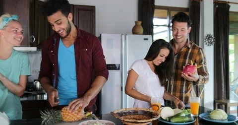 Two Couples In Kitchen Cooking Together, Young Woman And Man Group Talking Cut Stock Footage 81262508