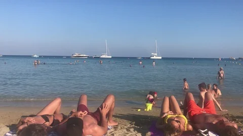 Two Couples Laying At The Beach Stock Footage 123537014