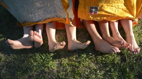 Two couples legs in tent Stock Footage 46677823