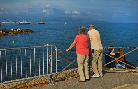 Two couples in love of different generations on the background of the bay wit Stock Photos