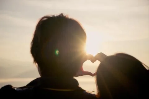 Two couples made a heart shape in the sky. Stock Photos
