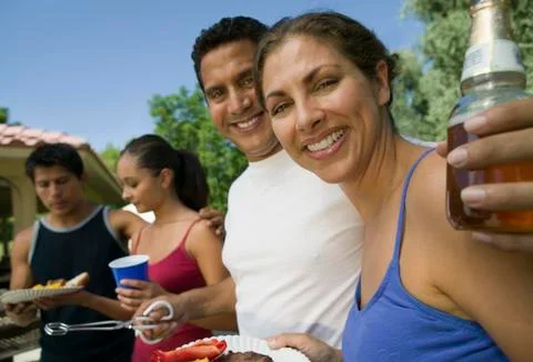 Two couples at outdoor picnic. Stock Photos