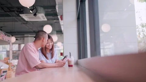 Two couples sat and talked while resting at a cafe.  Stock Footage 265230335