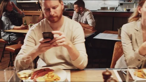Two couples sitting in restaurant at dinner. Stock Footage 125084264