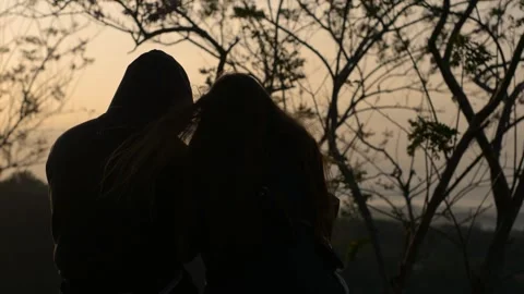 Two couples sitting watching the sunrise Stock Footage 314981363