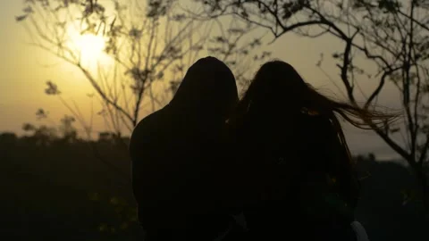 Two couples sitting watching the sunrise Stock Footage 314981373