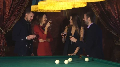 Two couples talking near the pool table and drink Stock Footage 70401037