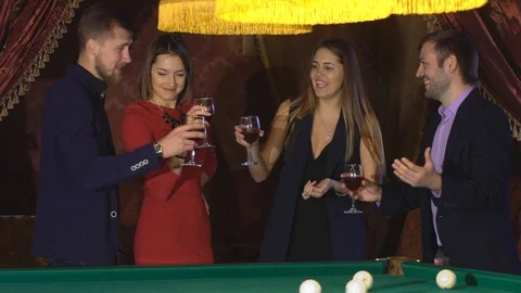 Two couples talking near the pool table and drink Video stock 70431221