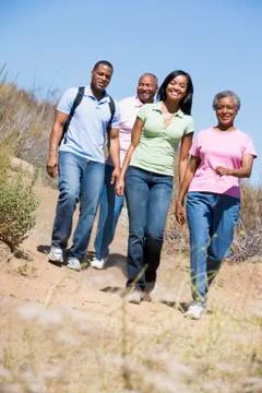 Two couples walking on path smiling Stock Photos