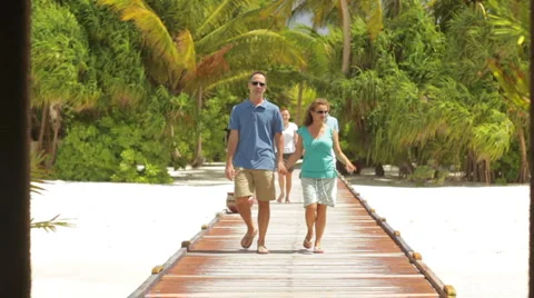 Two couples walking on tropical pier Stock Footage 1018719