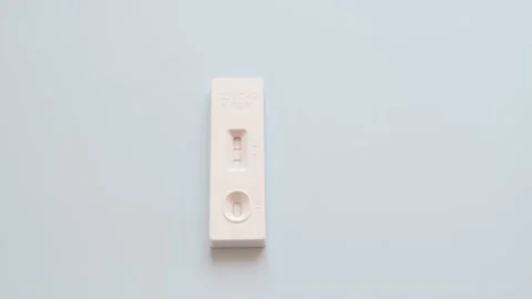 Two Covid-19 antigen rapid test devices tests, side by side on blue background 動画素材 170830196