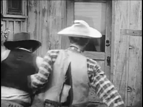 Two cowboys dragging man into sheriff's office, 1940s Stock Footage 61444945