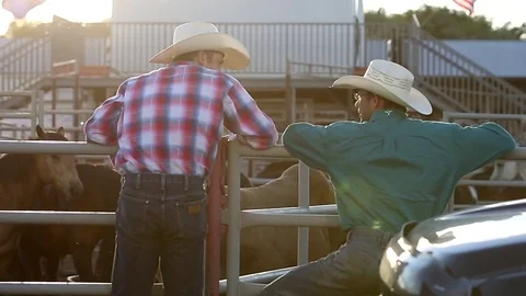 Two cowboys talk in the sunset Stock Footage 71309681