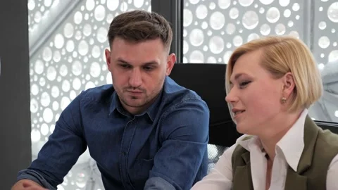 Two coworker colleagues sitting at table sharing project ideas strategy details. Video stock 149071008