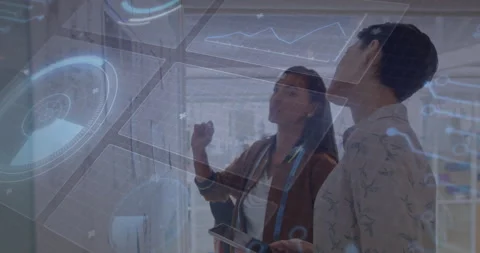 Two coworkers activating tech display raising hand and interacting with charts Stock Footage 311098493