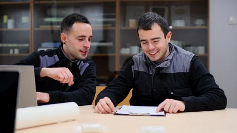 Two coworkers checking document during a meeting Stock Footage 265620677