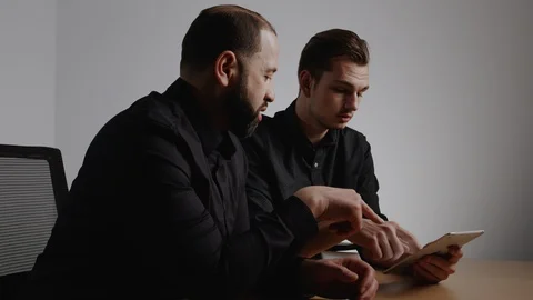 Two Coworkers Collaborating on an IPad Stock Footage 124699621
