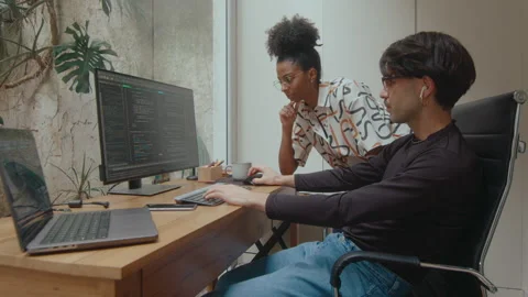 Two Coworkers Discussing Program Code on Computer Stock Footage 252759450