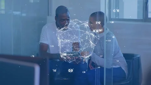 Two coworkers pointing at tablet behind glass causing digital sphere above Stock Footage 334178750