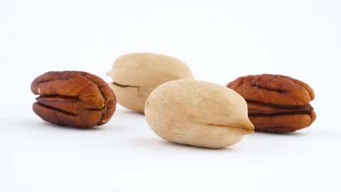 Two cracked pecan nuts and two kernels pecan nuts. Slowly rotating Stock Footage 95878299