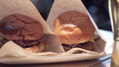 Two craft beef burgers on table. Fast food. Stock Footage 157287105