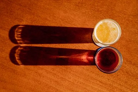 Two craft beers placed on a table with an interesting reflection and shade Stock Photos