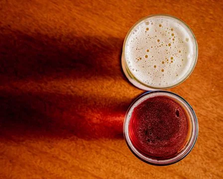 Two craft beers placed on a table with an interesting reflection and shade Stock Photos