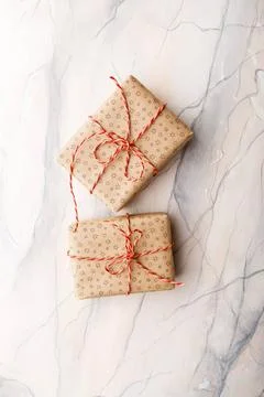 Two craft cardboard gift boxes Two gift boxes packed in craft paper on a b... Stock Photos