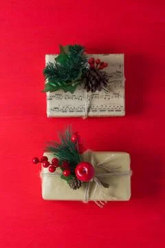 Two craft gift boxes decorated with brunch berries cones notes Stock Photos