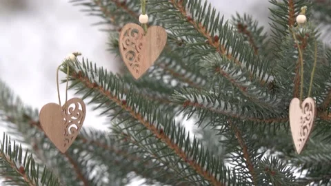 Two craft hearts hang on the tree; they develop from the wind Stock Footage 145352156