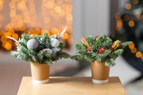 Two craft paper coffee cups on a wooden table. The concept of christmas coffee Stock Photos