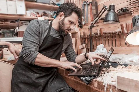 Two craftsmen violinmakers checking a new violin Stock Photos