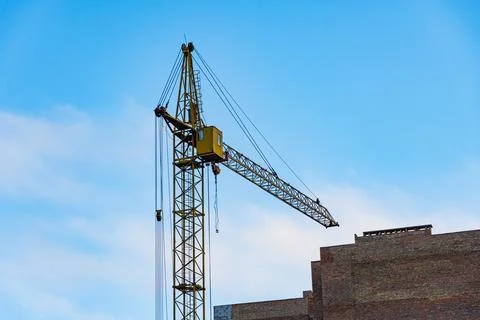 Two cranes are actively engaged at a large construction site, lifting mater.. Stock-Fotos