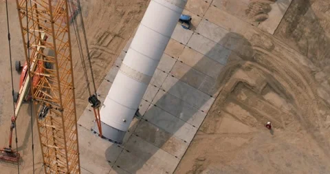Two cranes are lifting a huge pipe in desert. Stock Footage 138225158