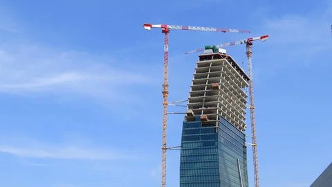Two cranes working to build a tall skyscraper in the old Milan expo district Stock-Footage 108542047