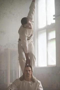 Two crazy men in straitjackets are in an abandoned clinic Stock Photos