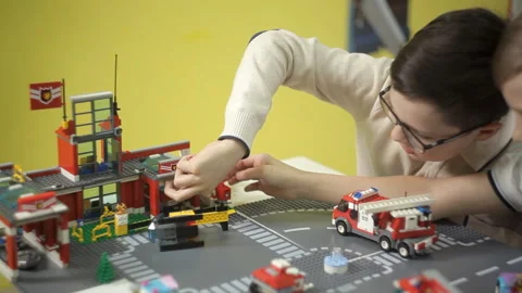 Two creative boys build from the cubes of the designer various objects Video stock 87958717