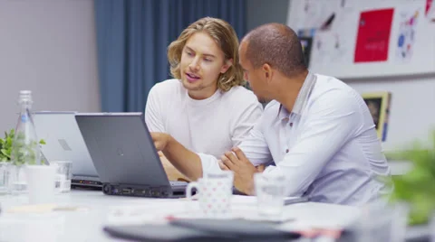 Two creative casual businessmen, working together and discussing ideas Stock Footage 32959774