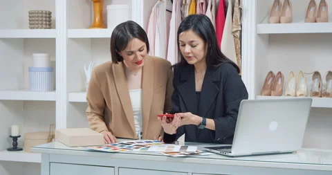 Two creative female designers choosing fabrics for tailoring a new collection of Stock Footage 202090029