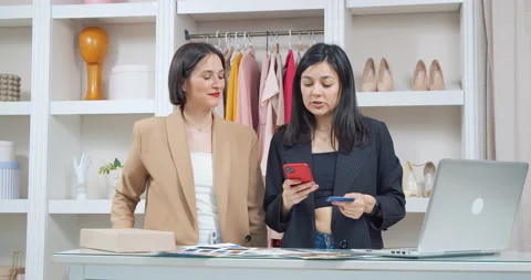 Two creative female designers choosing and ordering fabrics for a new clothing Stock Footage 233481355