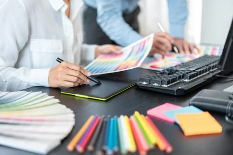 Two creative graphic designer team working on color selection and drawing o.. Stock Photos