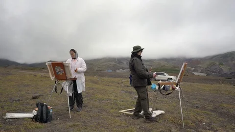 Two creative painters painting on canvas an easel autumn mountain landscape Stock Footage 126728856