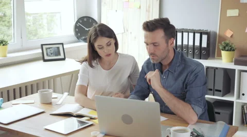 Two creative people working together in small office Stock Footage 64653920