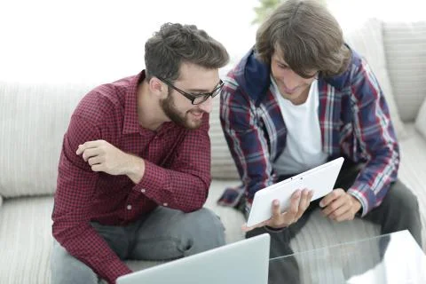 Two creative web designers working with a tablet and a laptop. Stock Photos