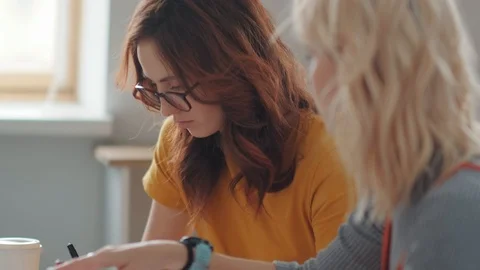 Two creative women work together, shot from the side. Stock-Footage 104101863