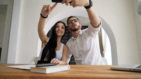 Two creative young job partners taking selfie at cellphone in workspace. Siesta Video stock 199491440