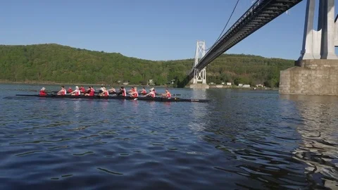 Two crew boats racing under the FDR bridge in Poughkeepsie, NY Stock Footage 80652847